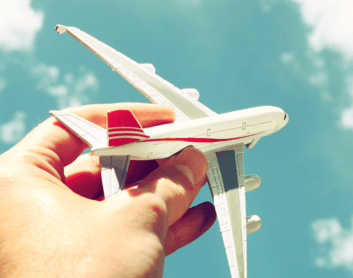 Toy airplane being held up in the sky