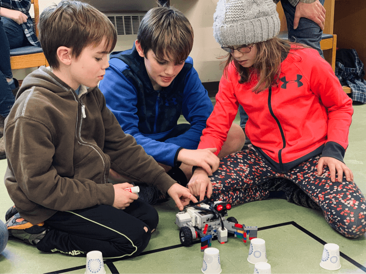 Kids at with lego robot during "Robo Olympics"